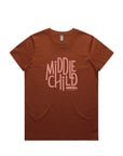 A clay brown coloured t-shirt is pictured flat against a white background. The t-shirt has the words middle child club written across the chest in graphic text in a rose pink colour.