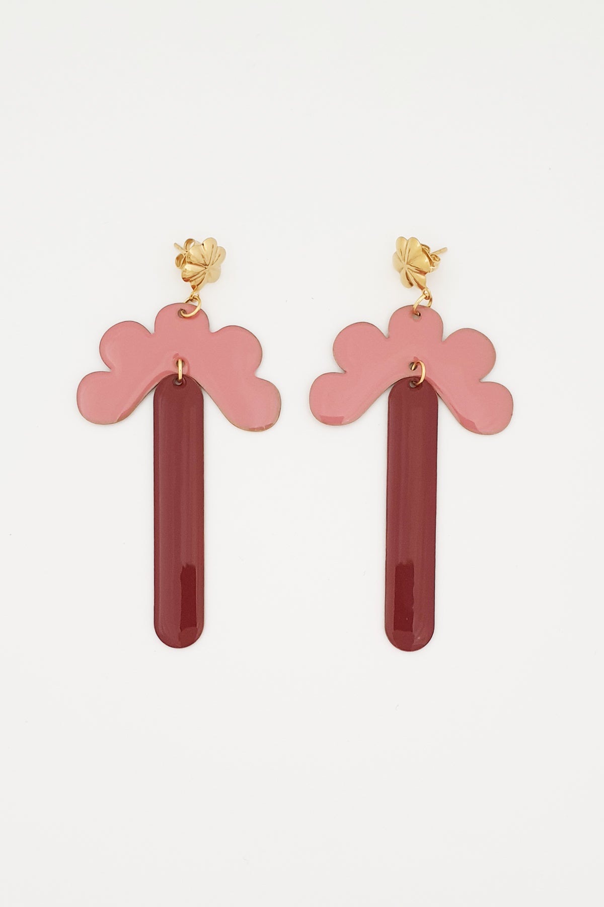 A pair of stud dangle earrings lay against a white background. They feature a gold flower shaped stud top, a pink enamel connector piece with resemblance to a half flower, and a coffee enamel drop.