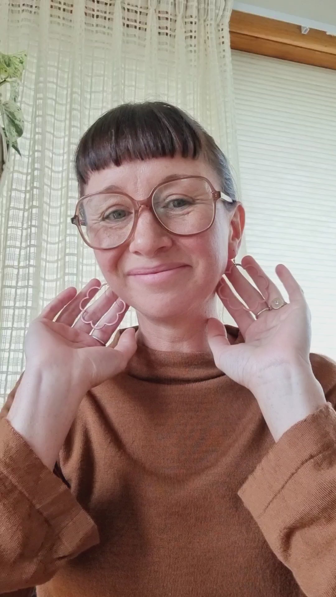 Lauren demonstrating our Pirouette earrings in pink enamel.