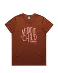 A clay brown coloured t-shirt is pictured flat against a white background. The t-shirt has the words middle child club written across the chest in graphic text in a rose pink colour.