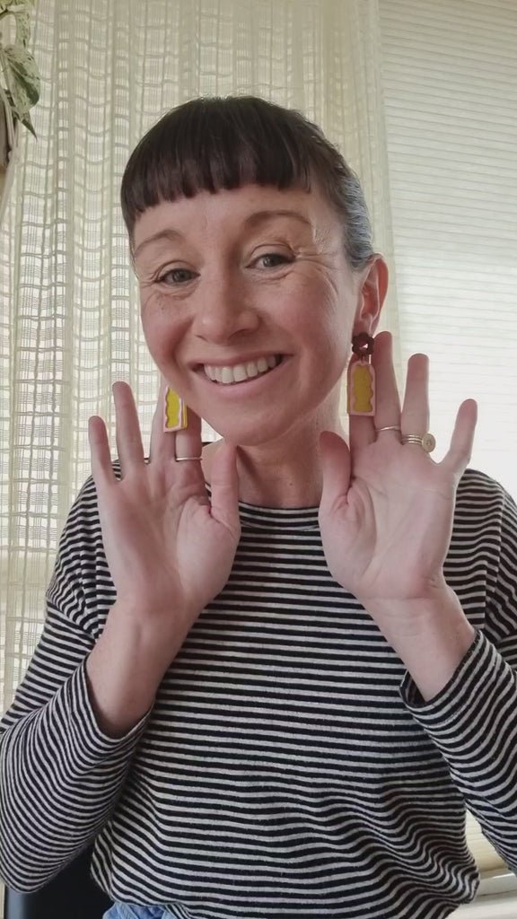 Lauren demonstrates our Mixtape earrings in yellow and pink combination.