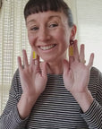 Lauren demonstrates our Mixtape earrings in yellow and pink combination.