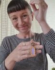 Lauren demonstrates the Mixtape necklace in the purple and orange colourway.