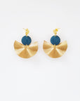 A pair of stud dangle earrings sit against a white background. They feature a teal enamel connector dot and a textured brass fan piece.