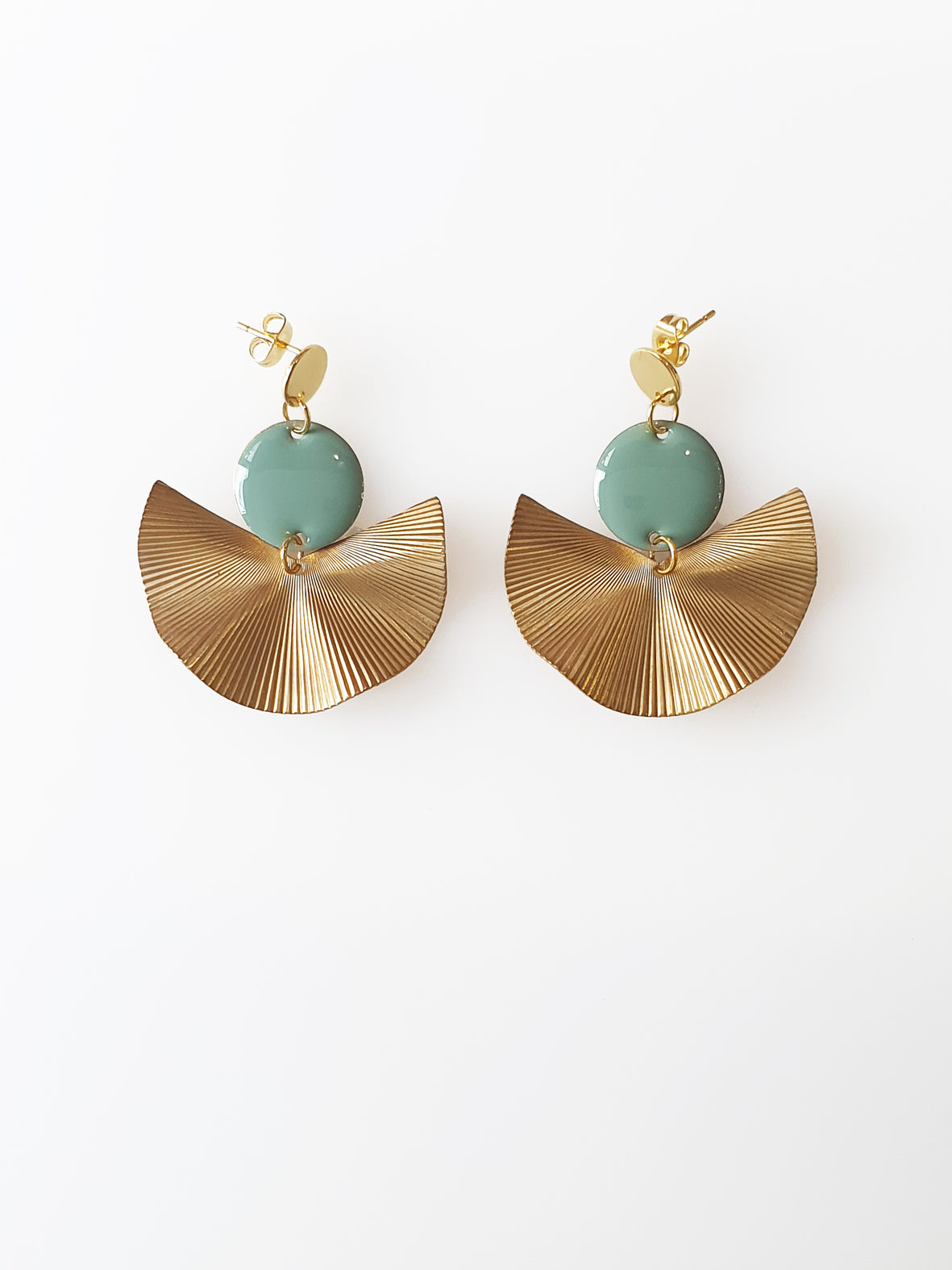 A pair of stud dangle earrings sit against a white background. They feature a duckegg enamel connector dot and a textured brass fan piece.