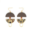 A pair of dangle earrings with a hook sit against a white background. They feature a brown arch shaped bead, a small wooden bead, a brown acrylic half circle, and an elongated D shape brass piece.