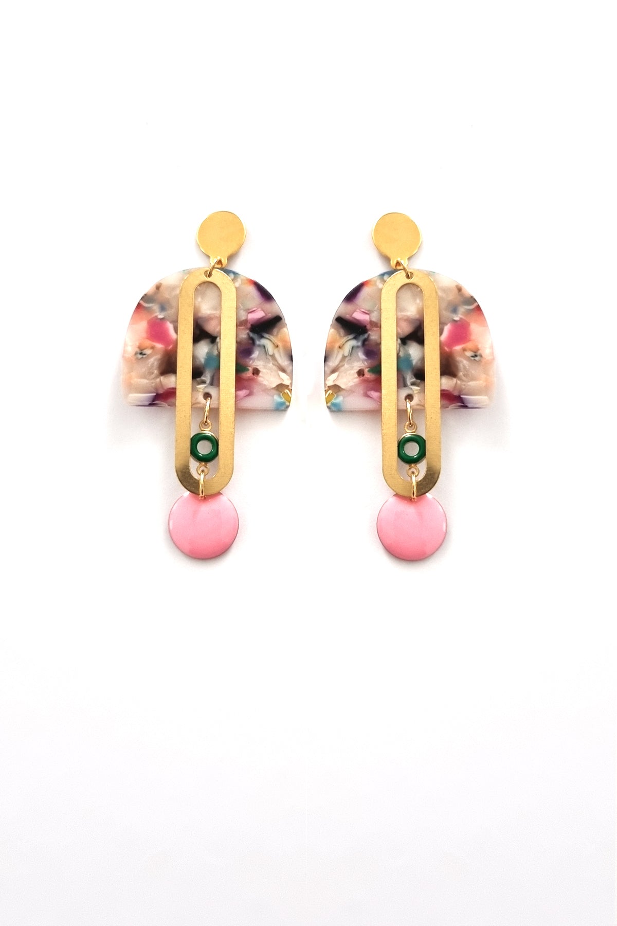 A pair of stud dangle earrings sits against a white background. They feature a multicoloured acrylic arch, an elongated oval brass piece with a small green enamel connector attaching the acrylic piece to the brass, and at the bottom hangs a pink enamel dot.