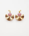 A pair of stud dangle earrings sit against a white background. They feature a mauve enamel connector dot and a textured brass fan piece.